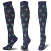 A pair of dark purple compression socks patterned with green cacti.
