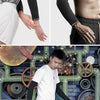 A model wearing black breathable cycling arm sleeves and black pants standing in front of a blue industrial background with g