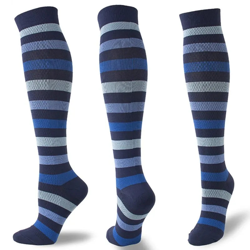 A set of multi-color striped compression socks in shades of blue and gray.