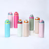 A collection of pink, green, and blue insulated stainless steel thermos mugs with straws arranged in a row and on a stand.
