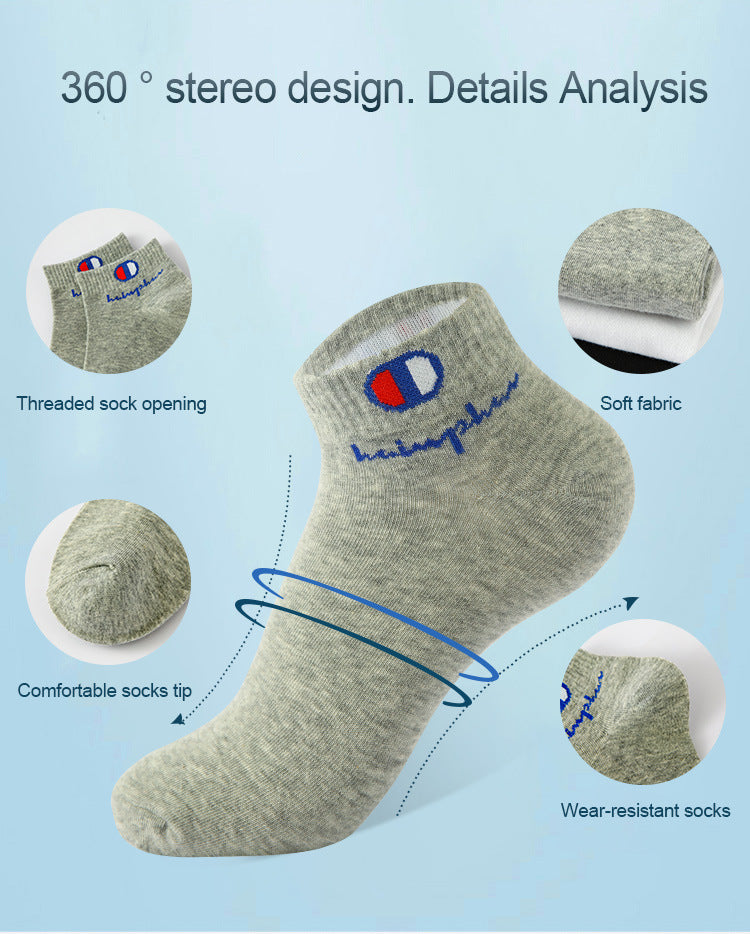 A gray ankle sock with a blue embroidered design showing features like threaded opening and soft fabric.