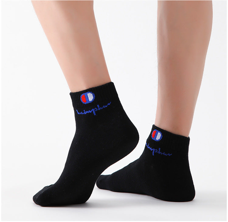 A pair of black ankle socks with a blue and white embroidered logo on the cuff.