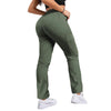 A woman wearing olive green drawstring cargo pants and a black top, viewed from the side.