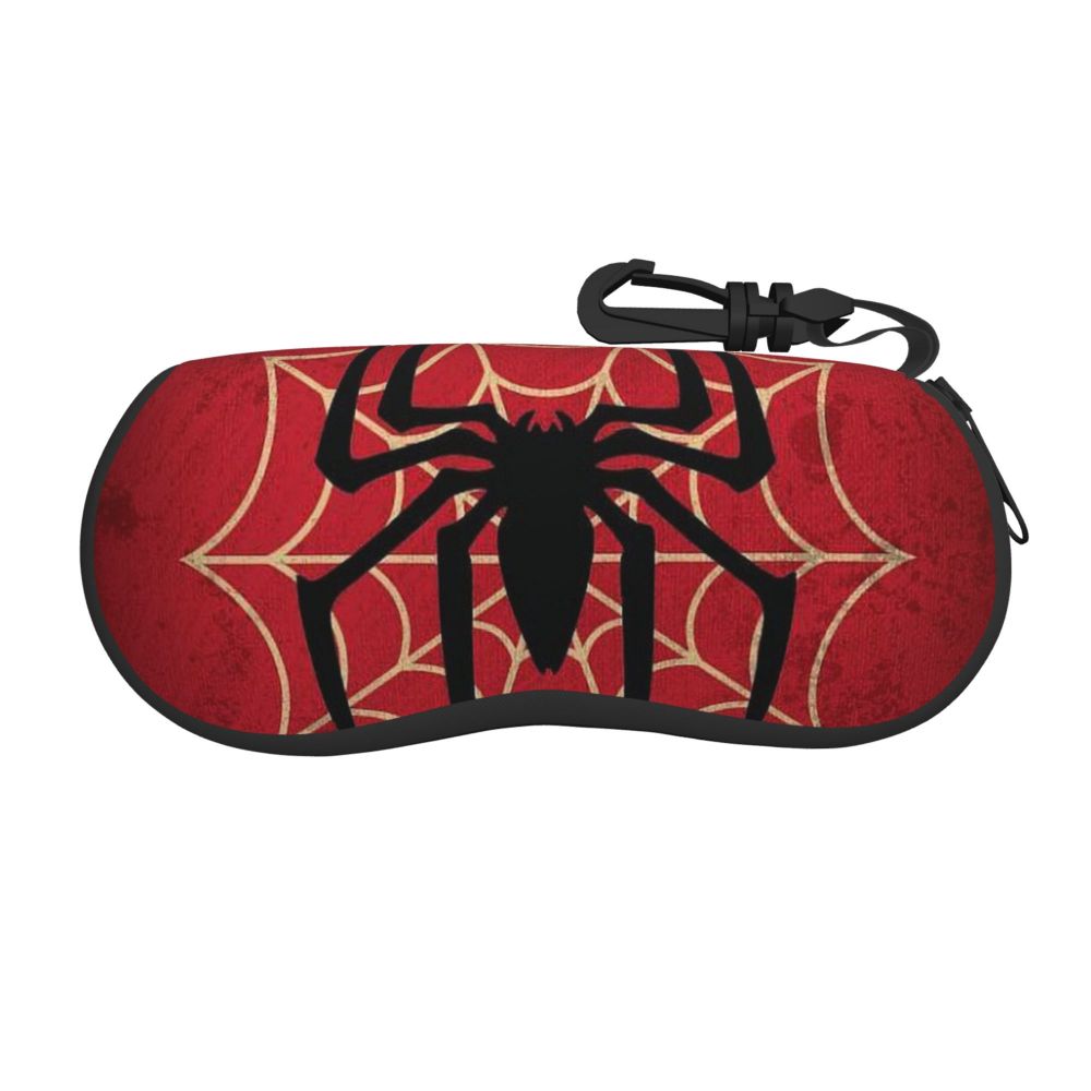 A red fabric pouch shaped like a spider web with a black spider design and a black strap.
