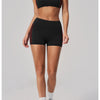 A woman models a black two-piece yoga and sports tracksuit set with red trim.