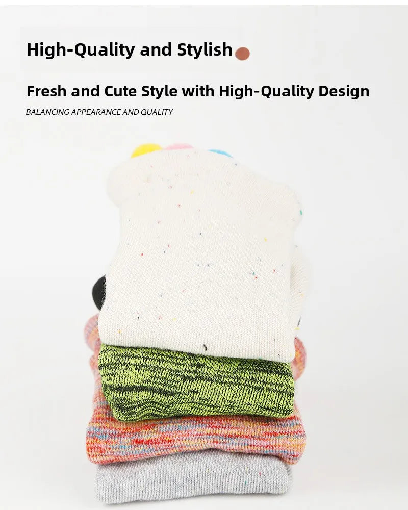 A stack of colorful five-finger yoga socks showing various textures and colors.