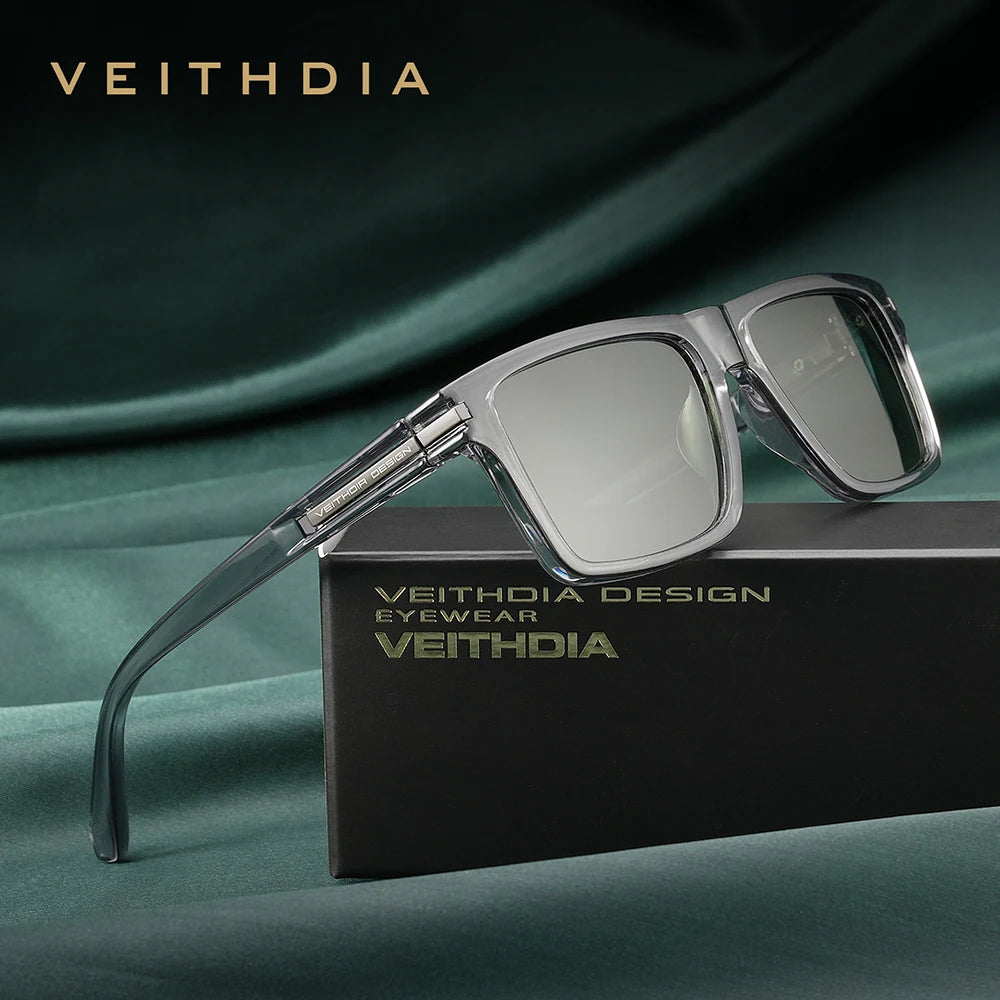 A pair of silver-framed Veithdia design eyeglasses resting on a dark box.