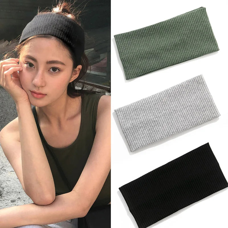 Three knitted headbands in black, olive green, and gray shown against a white background.