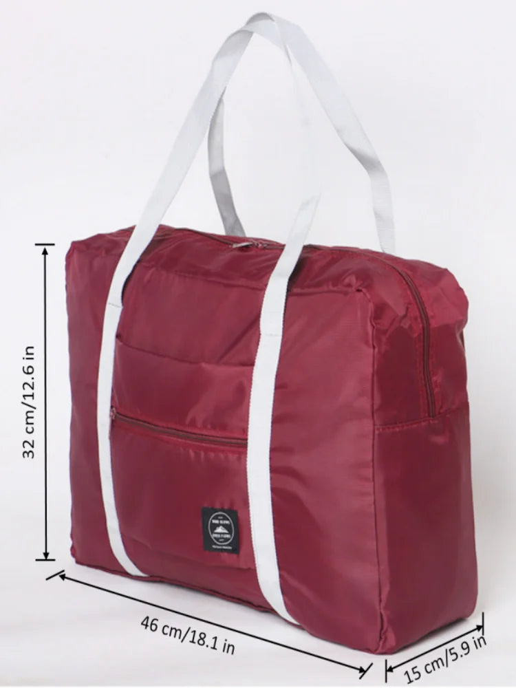 A maroon foldable travel duffel bag with white straps and handles shown flat.