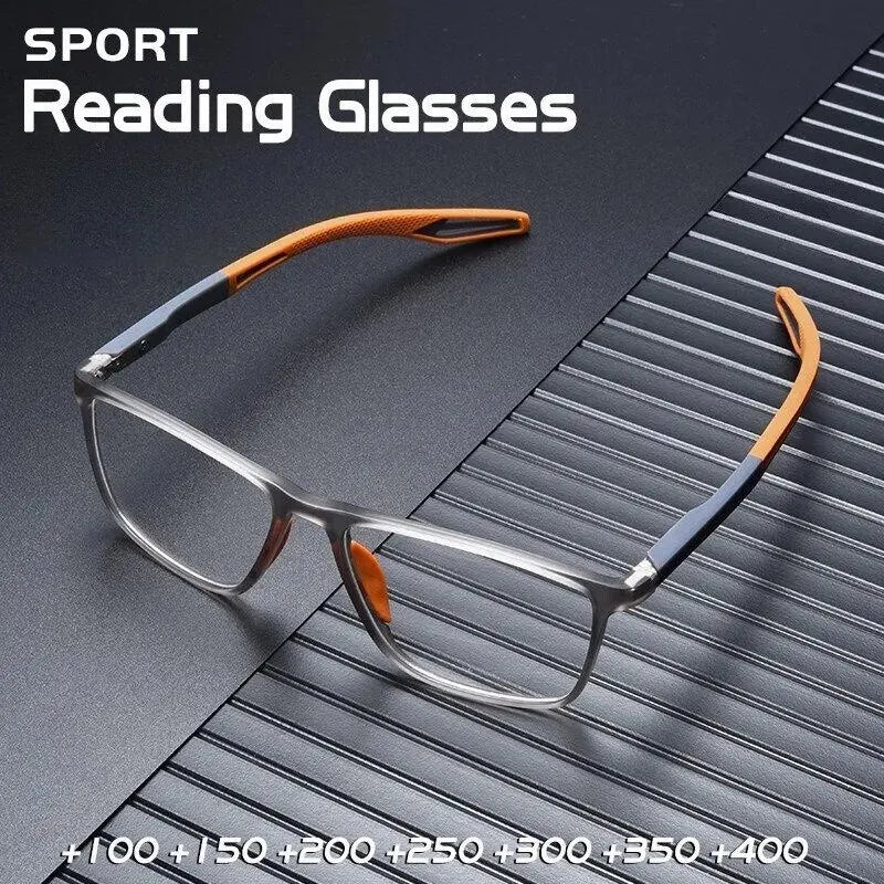 A pair of orange-framed sports reading glasses resting on a dark, textured surface.