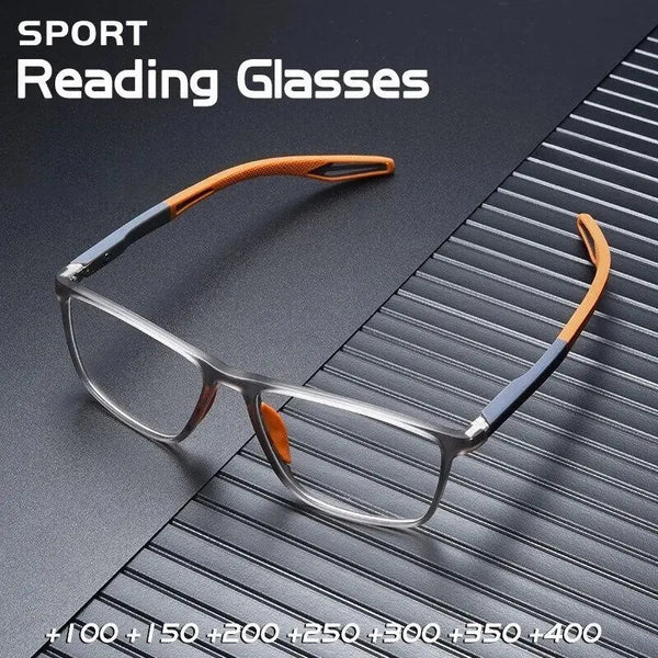 A pair of orange-framed sports reading glasses resting on a dark, textured surface.