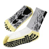 A pair of anti-slip training socks featuring a black and gray geometric pattern on the foot and a yellow cuff.
