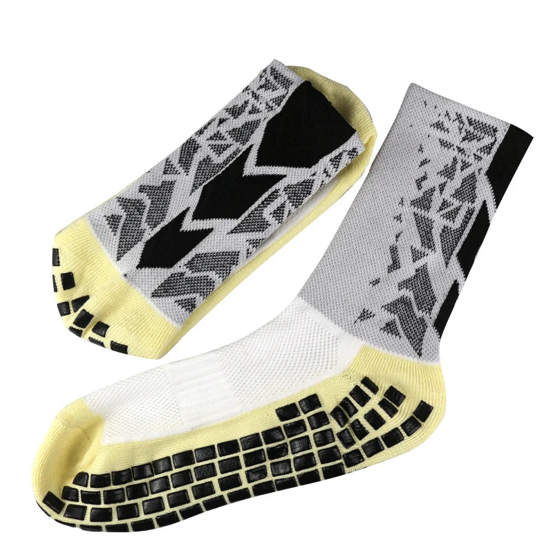 A pair of anti-slip training socks featuring a black and gray geometric pattern on the foot and a yellow cuff.