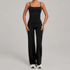 A woman wearing a black high-waist yoga and fitness tracksuit set with matching top and pants.