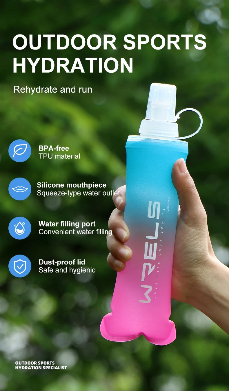 A hand holds a pink sports hydration bottle with a silicone mouthpiece, demonstrating outdoor sports hydration.