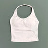 A white seamless performance yoga and gym tank top displayed against a solid gray background.