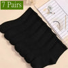 Sept paires de chaussettes en maille noires mi-mollet pour femmes, respirantes, sur fond clair.