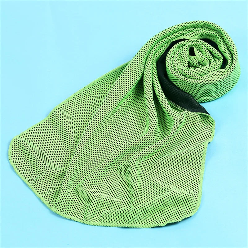 A lime green microfiber cooling towel is rolled up on a light blue surface.