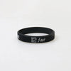 Black silicone wristband with white text reading 12-MT