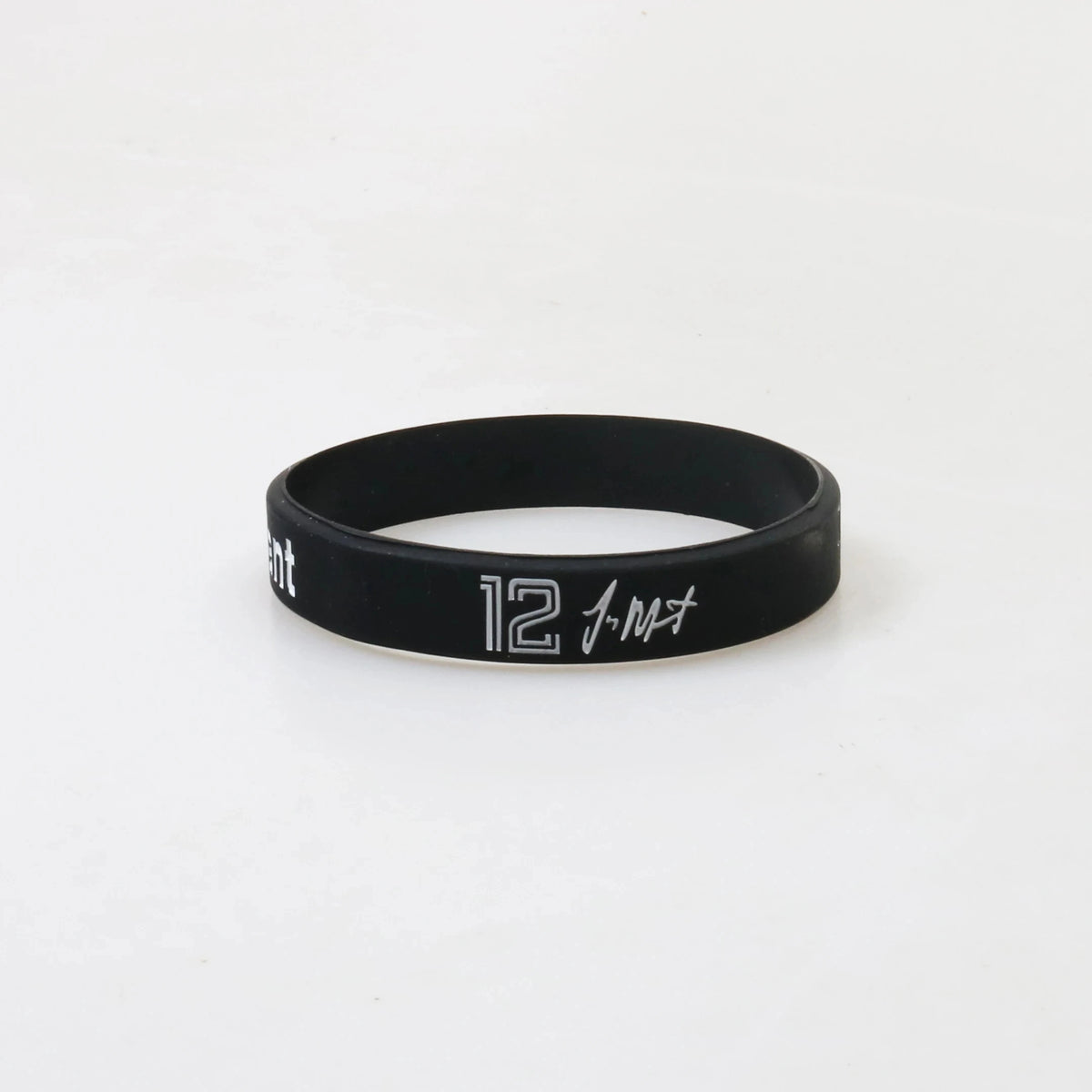 Black silicone wristband with white text reading 12-MT