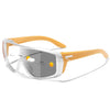 A pair of orange photochromic sports sunglasses with clear lenses and a flexible arm.