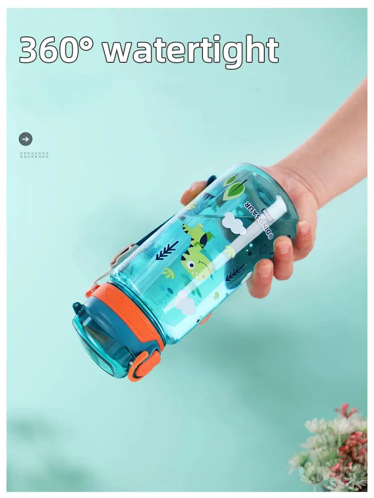 A hand holds a clear silicone straw water bottle shaped like a dinosaur for a child.