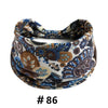 A patterned boho print cotton headband featuring blue, brown, and cream colors.