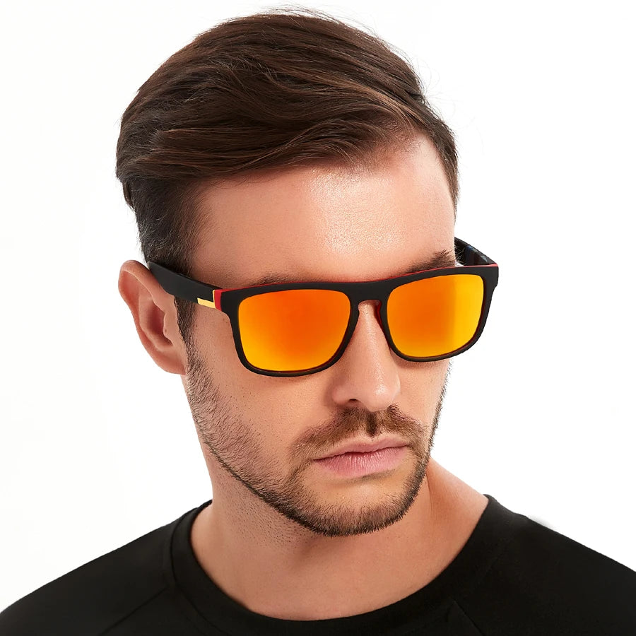 A man wearing orange-tinted square sunglasses with black frames against a white background.