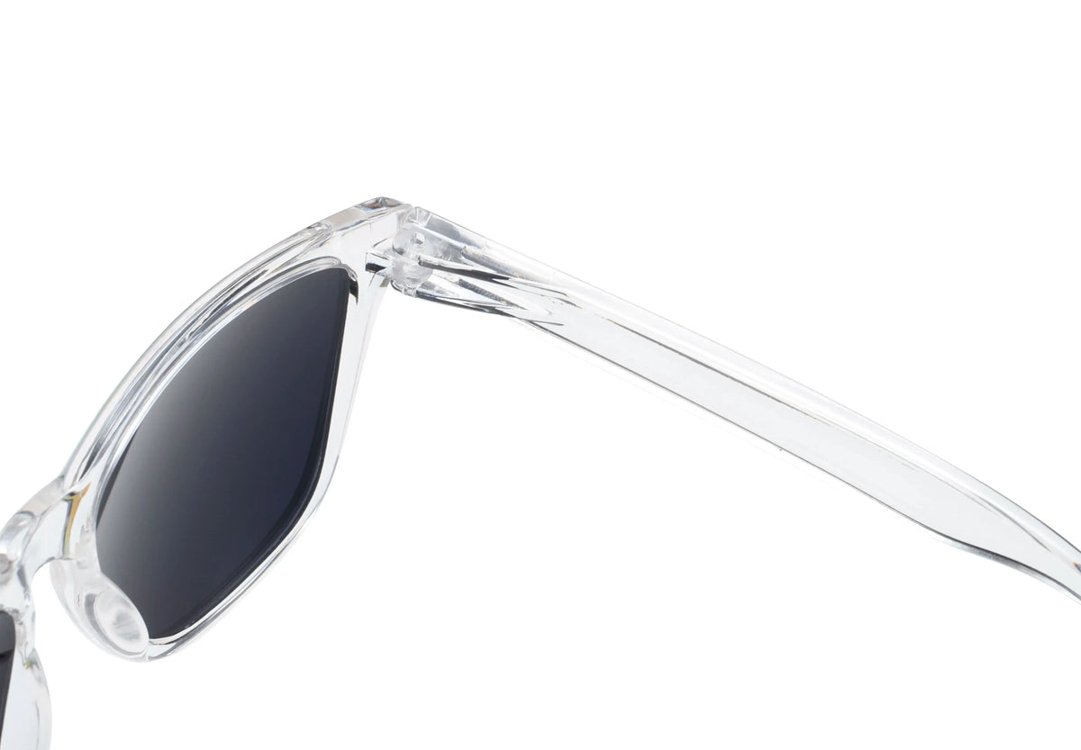Clear plastic frame sunglasses with dark mirrored lenses shown in profile view