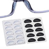 Clear silicone anti-slip nose pads for eyeglasses, packaged in a white plastic tray.