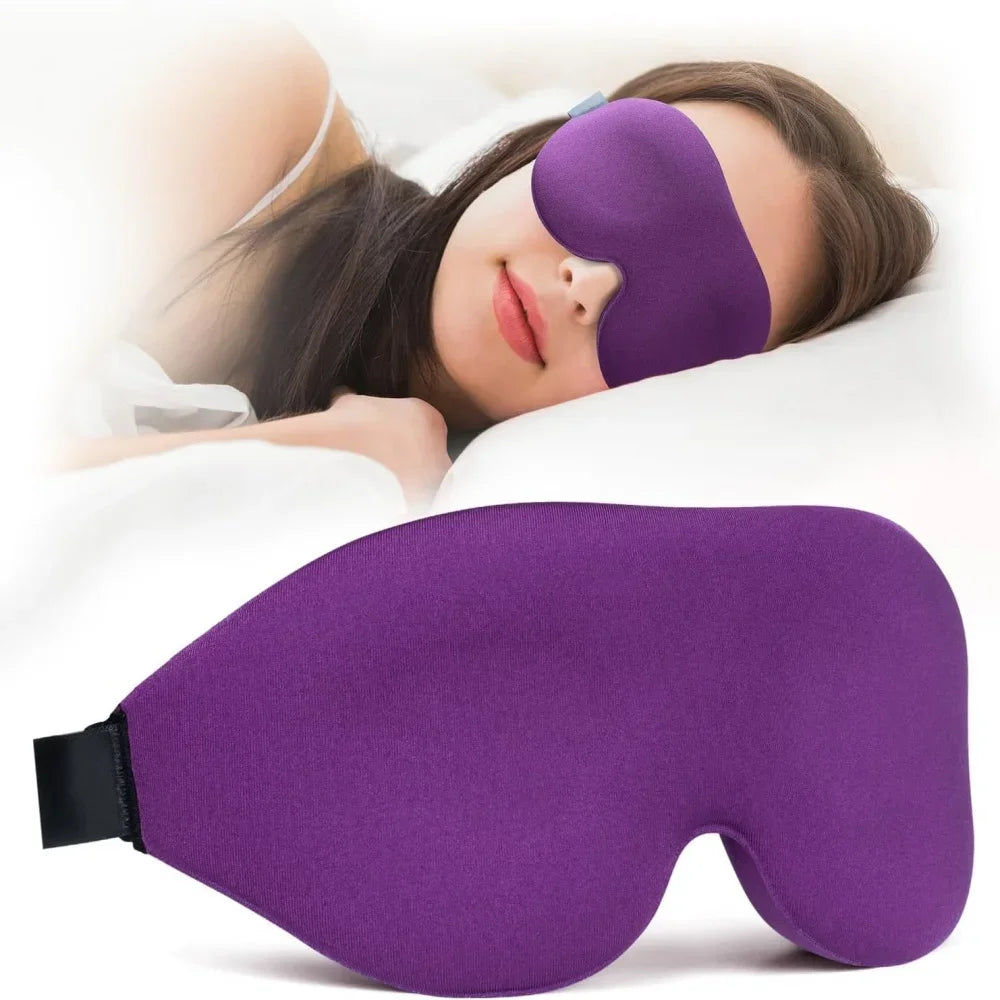 A purple light blocking sleep mask is shown being worn by a person resting on a white pillow.