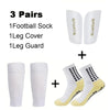 A set of three pairs of men's grip soccer socks, leg covers, and leg guards in white and yellow.