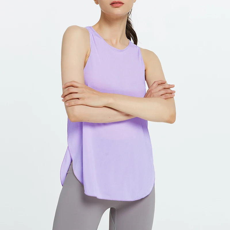 A woman wearing a light purple quick-dry yoga and gym tank top and gray leggings.