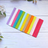A colorful bulk set of anti-slip elastic headbands arranged diagonally on a white wooden surface.