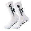 A pair of white anti-slip performance sports socks with black text and dots.