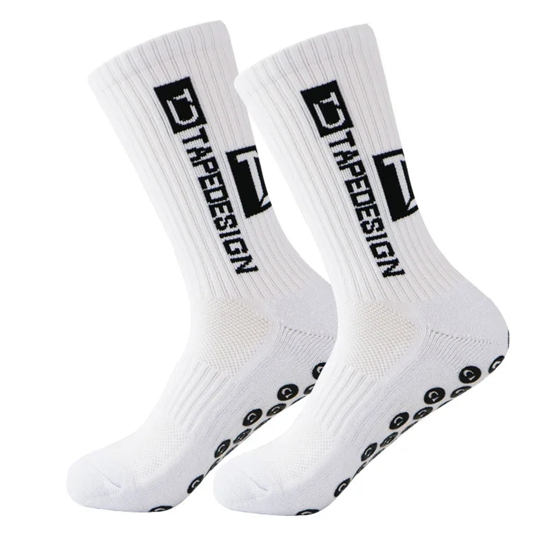 A pair of white anti-slip performance sports socks with black text and dots.