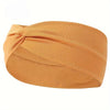 A tan knitted elastic sports headband is shown rolled and knotted for workouts or everyday wear.