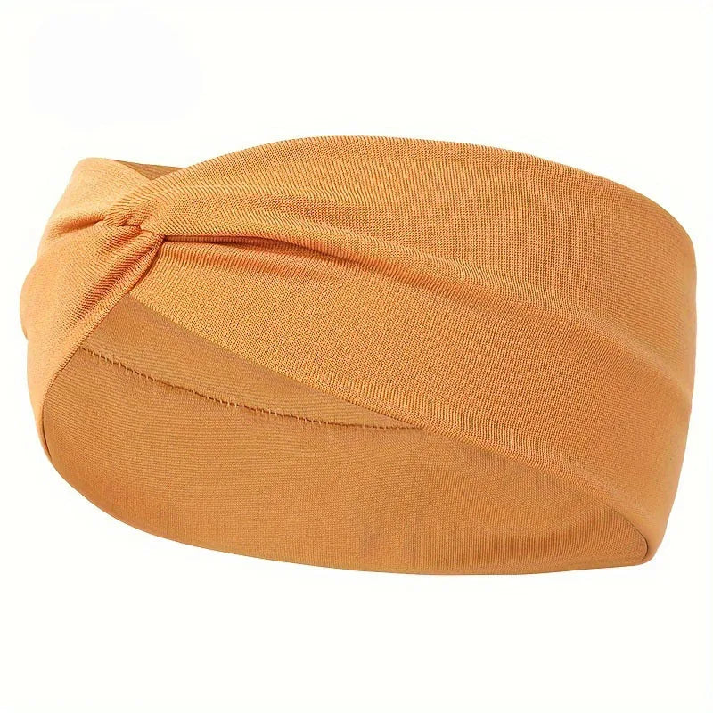 A tan knitted elastic sports headband is shown rolled and knotted for workouts or everyday wear.