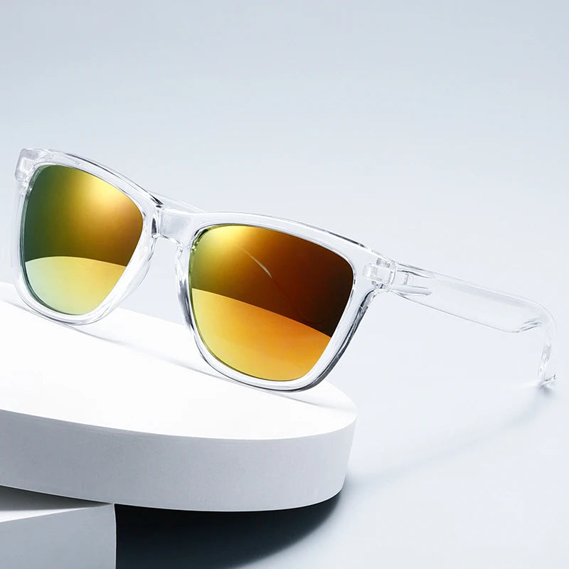 A pair of gradient mirrored sunglasses with amber and green lenses resting on a white surface.