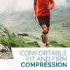 A person wearing an orange shirt and dark shorts is running on a dirt path, demonstrating comfortable fit and firm compressio