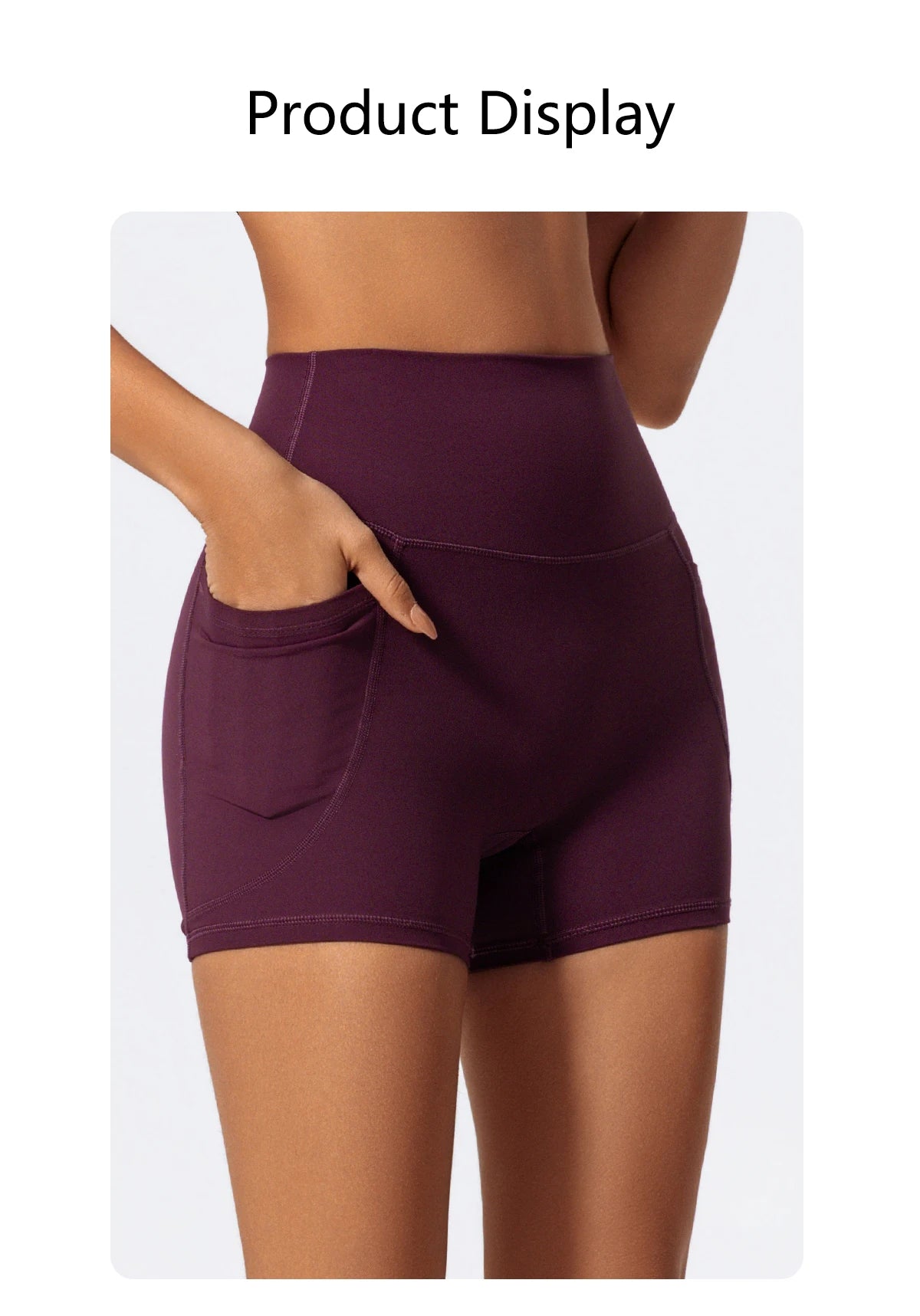 A model displays a pair of dark purple high-waist yoga and workout shorts.