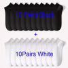 A display of 10 pairs of black and 10 pairs of white comfort fit ankle socks.