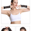 A woman demonstrates a black copper fiber wrist bracer for fitness and sport.