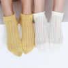 A pair of yellow and white breathable mesh lace tube socks for women