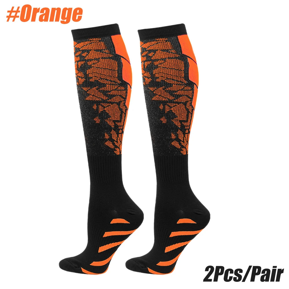 A pair of orange and black compression socks for sports or medical use.