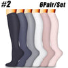 A set of six pairs of compression socks in various shades of gray, black, and pink displayed vertically.