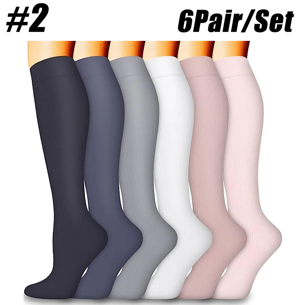 A set of six pairs of compression socks in various shades of gray, black, and pink displayed vertically.
