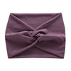 A purple women's elastic sports headband folded and tied in a knot.