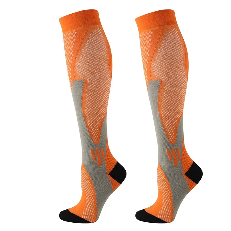 A pair of orange compression socks with gray accents, shown from the side.