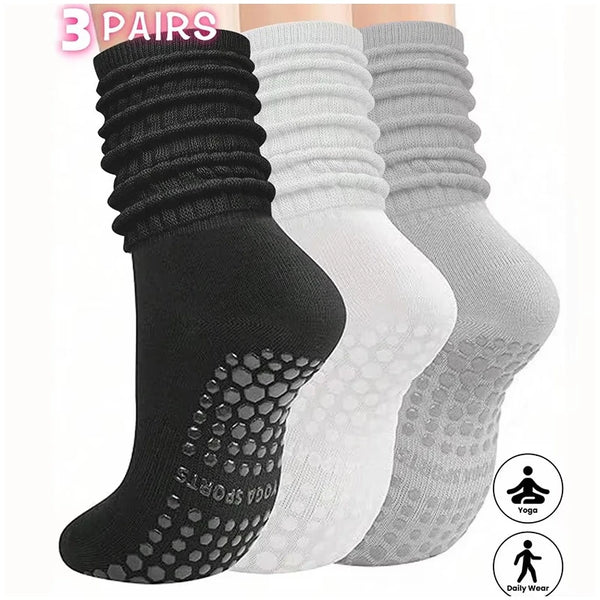 A set of three pairs of black, white, and gray silicone socks for Pilates and yoga